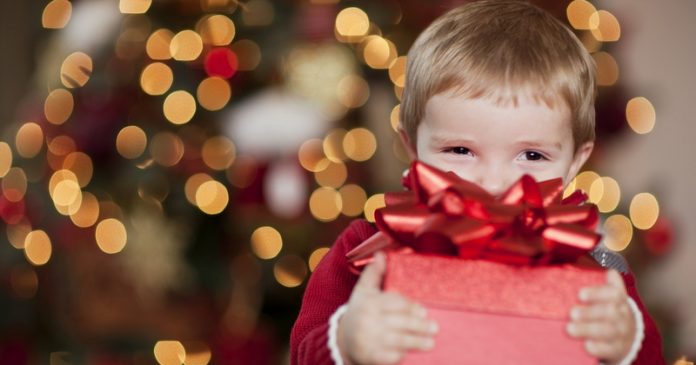 Young Boy Smiles with his Christmas Present
