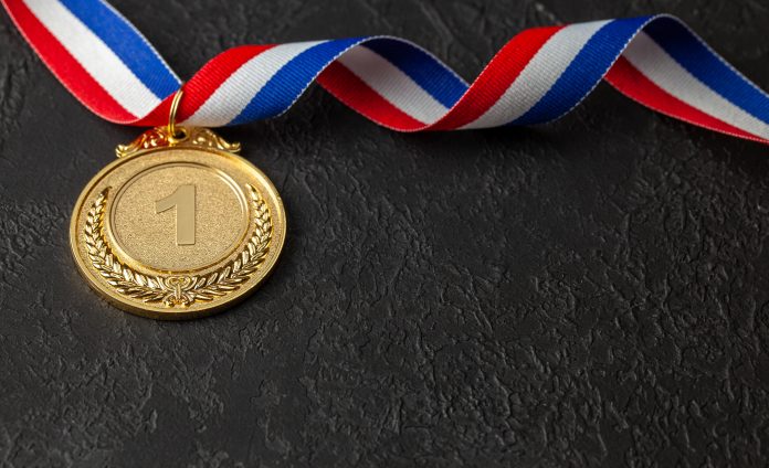 Gold medal with ribbons. Award for first place in the competition. Prize to the champion. Black background